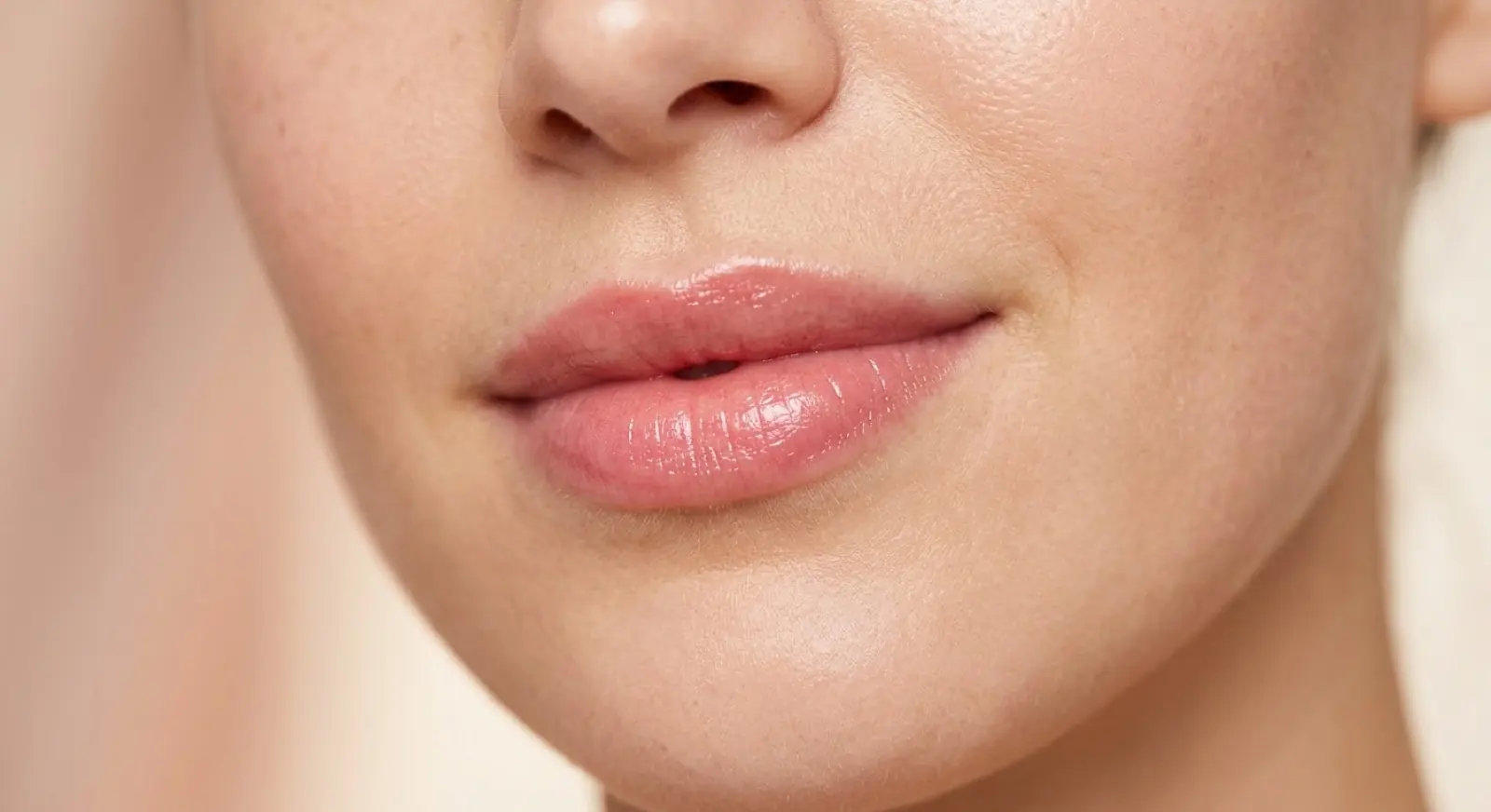 Close-up of natural pink glossy lips